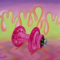 a pink bicycle sprocket on a colorful background